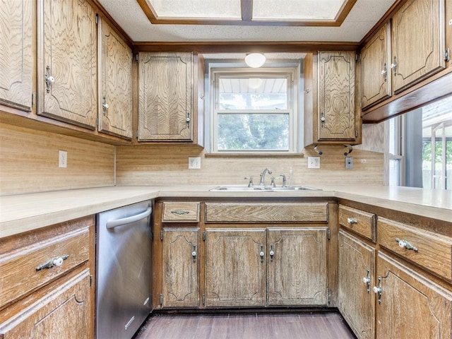 804 Royal Ln, Yukon, OK 73099 - kitchen featuring stainless steel dishwasher, light countertops, wood finished floors, and brown cabinetry