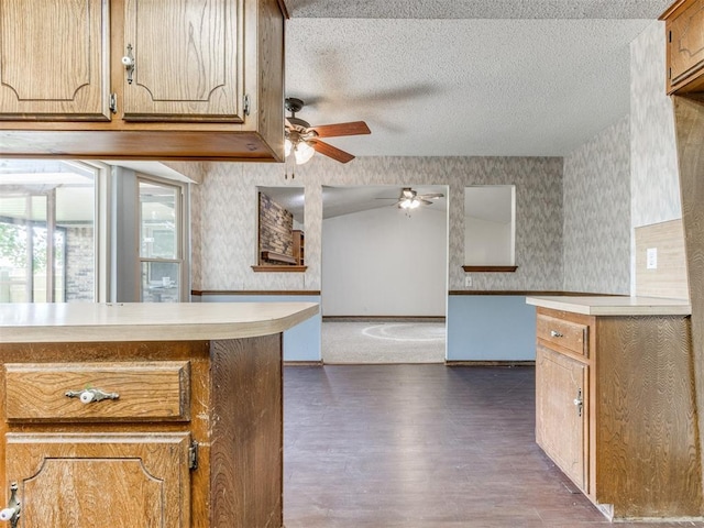 804 Royal Ln, Yukon, OK 73099 - kitchen featuring wallpapered walls, ceiling fan, light countertops, dark wood-style flooring, and a textured ceiling
