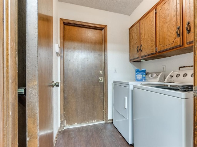 804 Royal Ln, Yukon, OK 73099 - laundry room with washing machine and clothes dryer, dark wood finished floors, cabinet space, and a textured ceiling
