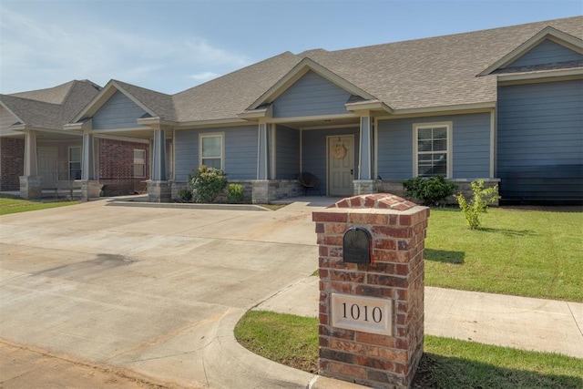 1010 SW 91st St, Oklahoma City, OK 73139 - craftsman-style house featuring roof with shingles, a porch, and a front lawn