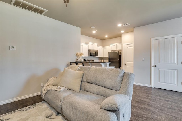 1010 SW 91st St, Oklahoma City, OK 73139 - living room featuring wood finished floors and recessed lighting