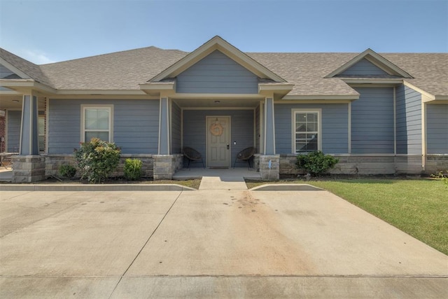 1010 SW 91st St, Oklahoma City, OK 73139 - view of front facade featuring roof with shingles, a front yard, and stone siding