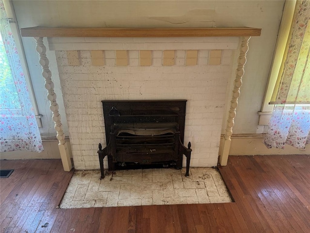 detailed view of wood finished floors and a fireplace