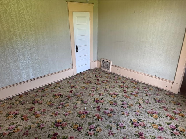 carpeted empty room with baseboards