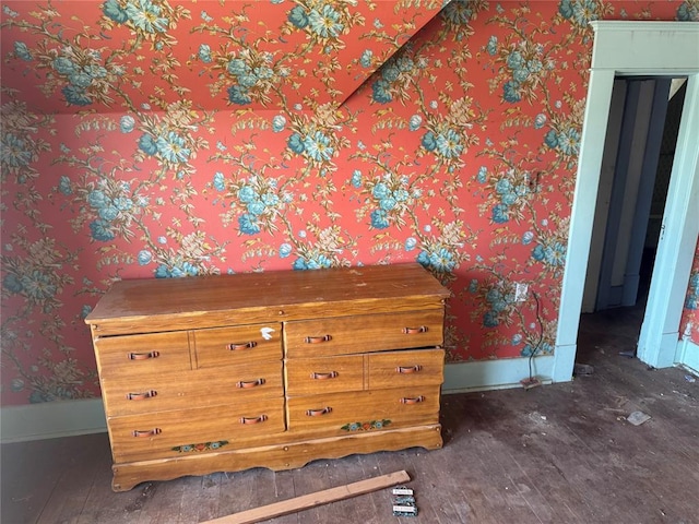 detailed view of wallpapered walls and wood finished floors