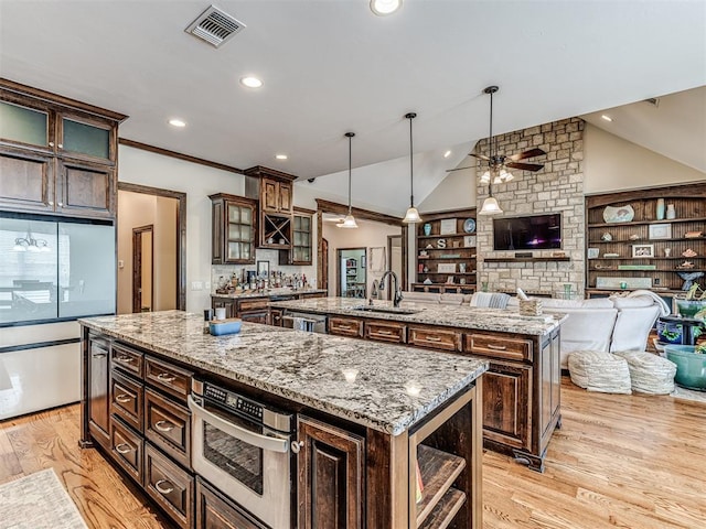 4311 Moorgate Dr, Norman, OK 73072 - kitchen featuring a kitchen island with sink, a ceiling fan, stainless steel appliances, light wood-type flooring, and recessed lighting