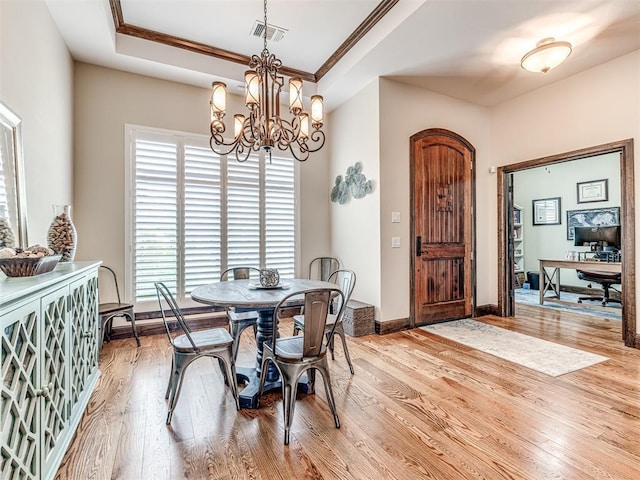 4311 Moorgate Dr, Norman, OK 73072 - dining room with a chandelier, light wood-style flooring, ornamental molding, and a tray ceiling