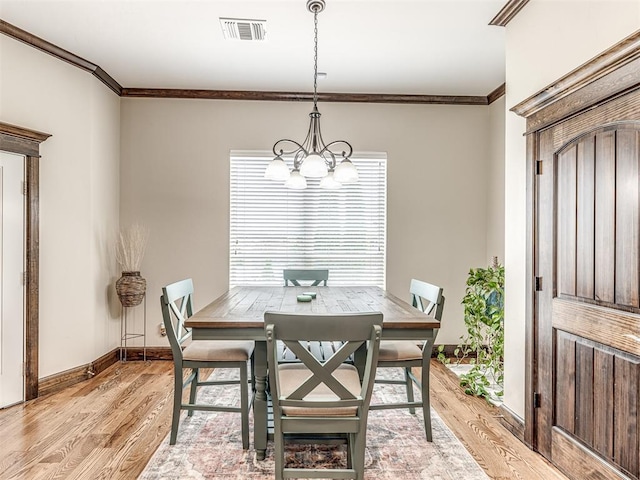 4311 Moorgate Dr, Norman, OK 73072 - dining room featuring light wood-style floors, a chandelier, and crown molding