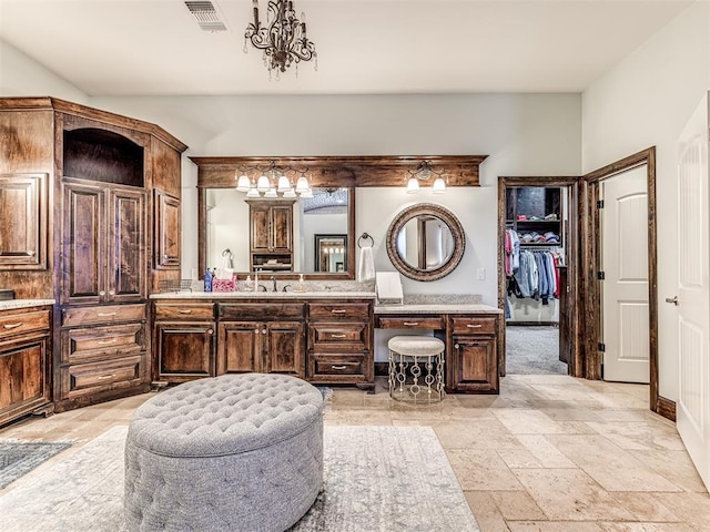 4311 Moorgate Dr, Norman, OK 73072 - full bath featuring vanity, stone tile flooring, and a walk in closet