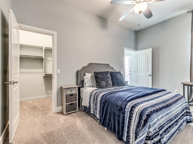 4311 Moorgate Dr, Norman, OK 73072 - bedroom featuring light carpet, a walk in closet, a closet, and ceiling fan