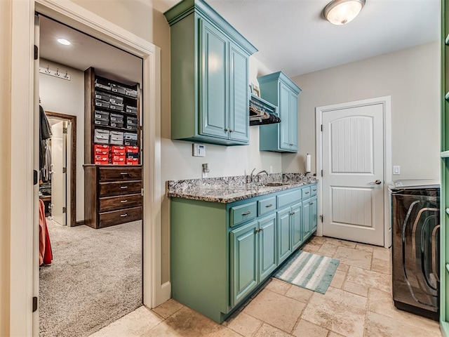 4311 Moorgate Dr, Norman, OK 73072 - washroom featuring cabinet space, washer / dryer, and stone tile flooring