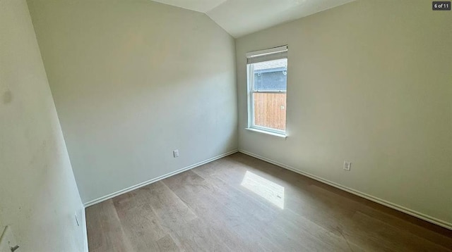 1614 SW C Ave, Lawton, OK 73501 - spare room featuring wood finished floors and vaulted ceiling