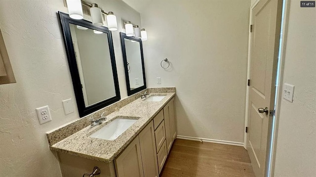 1614 SW C Ave, Lawton, OK 73501 - bathroom with double vanity, wood finished floors, and a textured wall