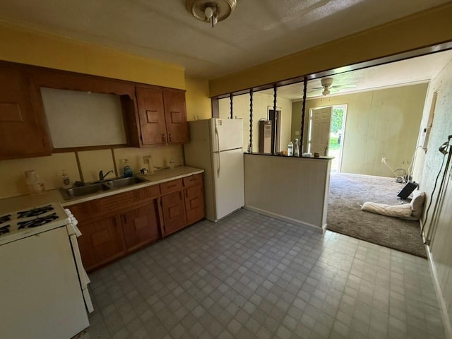 8821 NE 50th St, Spencer, OK 73084 - kitchen with white appliances, light countertops, a ceiling fan, tile patterned floors, and brown cabinetry