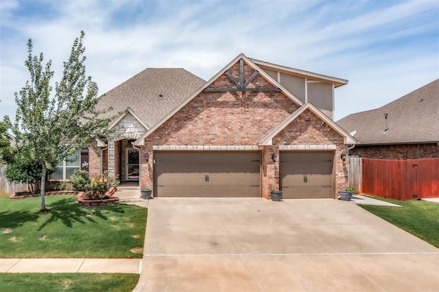 3309 Austrian Pine Ln, Yukon, OK 73099 - view of front of property with brick siding, a garage, driveway, and a shingled roof