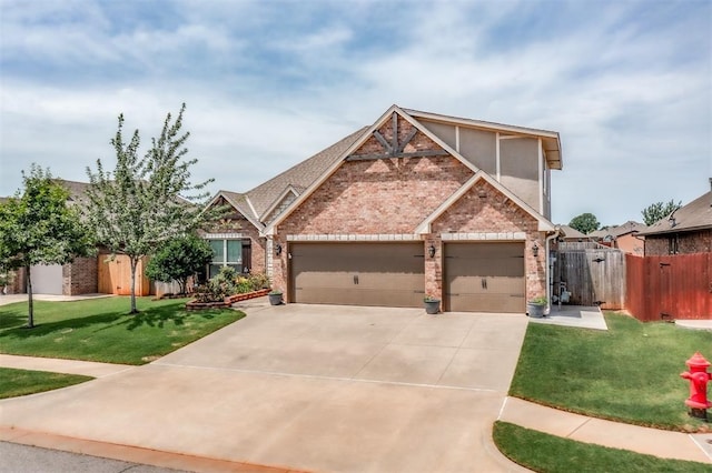 3309 Austrian Pine Ln, Yukon, OK 73099 - view of front of property featuring brick siding, an attached garage, and concrete driveway