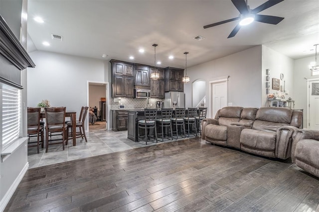 3309 Austrian Pine Ln, Yukon, OK 73099 - living area with ceiling fan, light wood-style floors, recessed lighting, and arched walkways