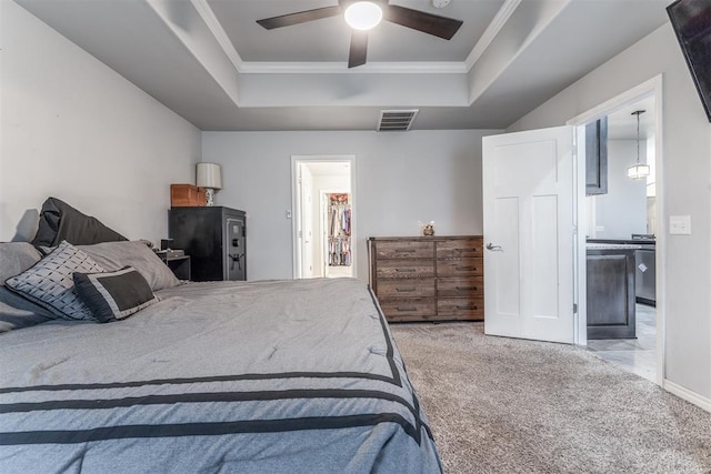 3309 Austrian Pine Ln, Yukon, OK 73099 - bedroom with a tray ceiling, carpet floors, crown molding, connected bathroom, and a ceiling fan