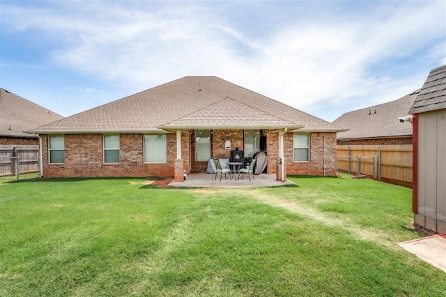 3309 Austrian Pine Ln, Yukon, OK 73099 - rear view of house featuring a fenced backyard, brick siding, a patio, and roof with shingles