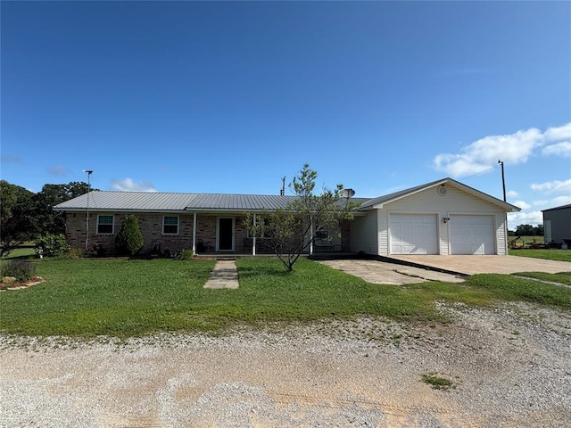 35352 Ew 1260th Rd, Seminole, OK 74868 - ranch-style house featuring concrete driveway, a front lawn, an attached garage, and a metal roof