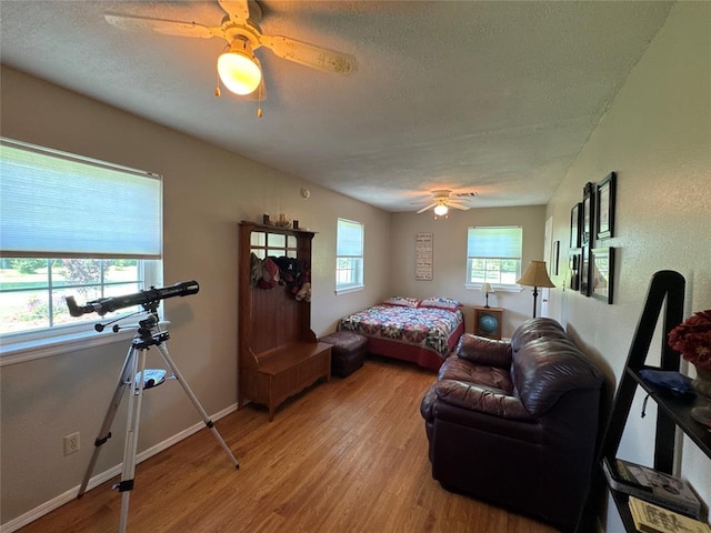 35352 Ew 1260th Rd, Seminole, OK 74868 - bedroom featuring light wood-type flooring, a textured ceiling, and ceiling fan