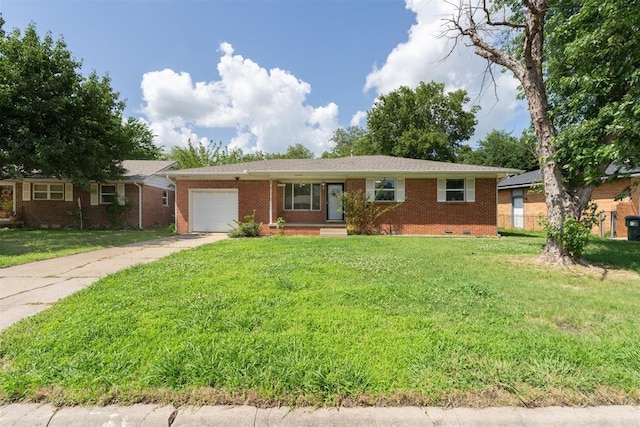 709 W Hughbert St, Norman, OK 73069 - ranch-style home featuring a garage, concrete driveway, a front lawn, and brick siding