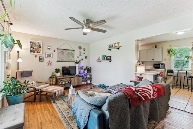 709 W Hughbert St, Norman, OK 73069 - living area with a ceiling fan, a textured ceiling, and light wood finished floors