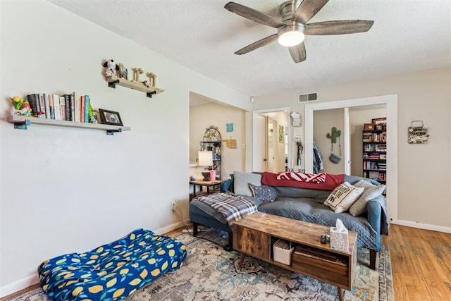 709 W Hughbert St, Norman, OK 73069 - living area with ceiling fan, wood finished floors, and a textured ceiling
