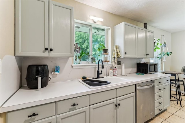 709 W Hughbert St, Norman, OK 73069 - kitchen with stainless steel appliances, light countertops, and light tile patterned floors