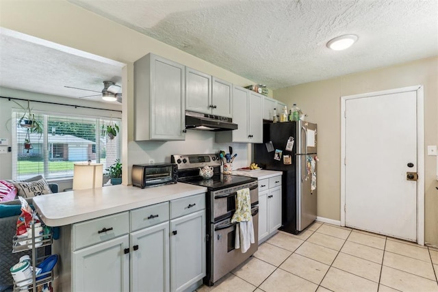 709 W Hughbert St, Norman, OK 73069 - kitchen featuring appliances with stainless steel finishes, under cabinet range hood, a textured ceiling, a ceiling fan, and light countertops
