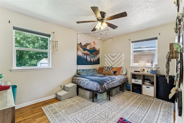 709 W Hughbert St, Norman, OK 73069 - bedroom with wood finished floors, a textured ceiling, and a ceiling fan