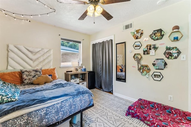 709 W Hughbert St, Norman, OK 73069 - bedroom featuring a textured ceiling and a ceiling fan