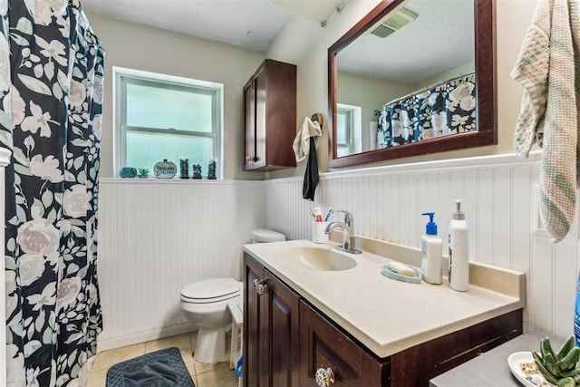 709 W Hughbert St, Norman, OK 73069 - bathroom featuring a wainscoted wall, vanity, and tile patterned flooring
