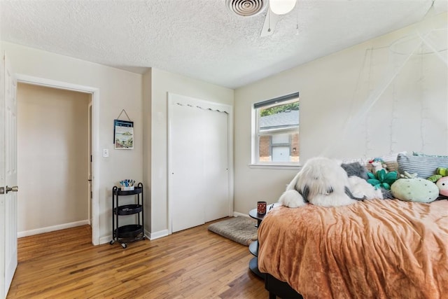 709 W Hughbert St, Norman, OK 73069 - bedroom featuring light wood-style floors, a closet, and a textured ceiling