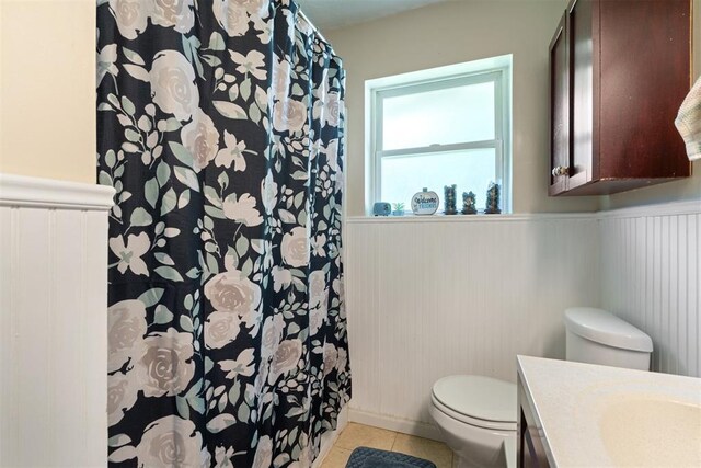 709 W Hughbert St, Norman, OK 73069 - bathroom featuring wainscoting, vanity, tile patterned floors, and curtained shower