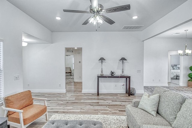 12712 NW 4th St, Yukon, OK 73099 - living room with light wood-style flooring, a ceiling fan, recessed lighting, and a chandelier