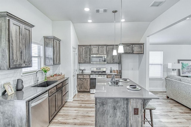 12712 NW 4th St, Yukon, OK 73099 - kitchen with appliances with stainless steel finishes, light wood-type flooring, tasteful backsplash, and recessed lighting
