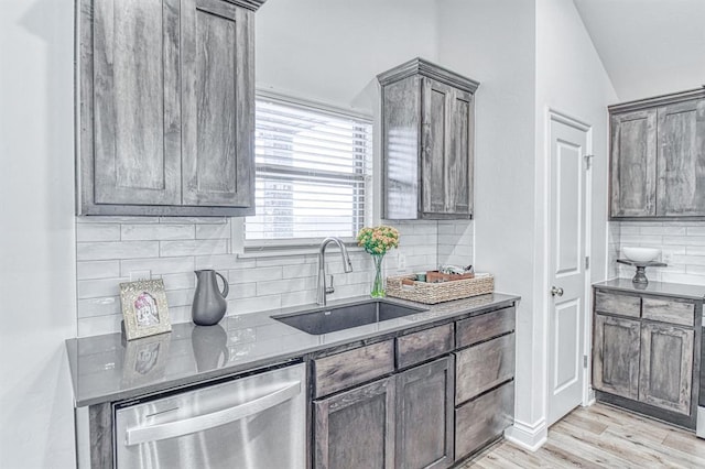 12712 NW 4th St, Yukon, OK 73099 - kitchen with dishwasher, decorative backsplash, light wood-style flooring, and lofted ceiling