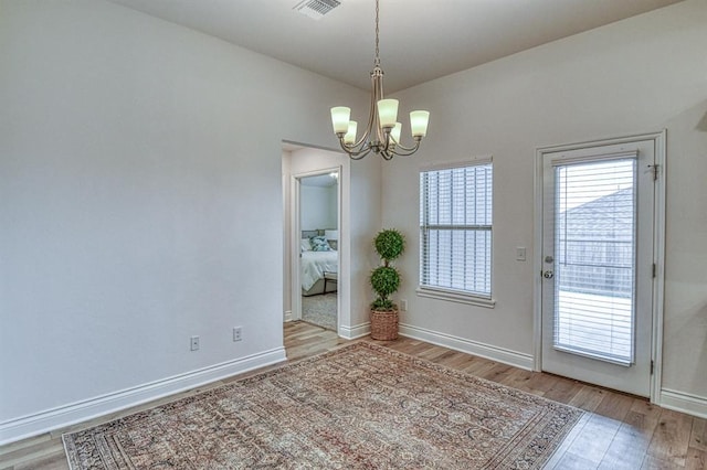 12712 NW 4th St, Yukon, OK 73099 - unfurnished dining area featuring a chandelier and wood finished floors