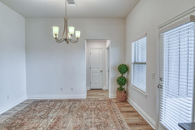 12712 NW 4th St, Yukon, OK 73099 - unfurnished dining area featuring light wood-type flooring and a chandelier