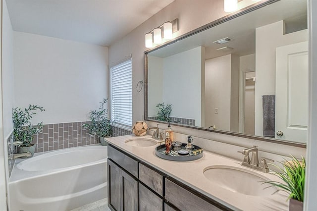 12712 NW 4th St, Yukon, OK 73099 - bathroom featuring a garden tub and double vanity