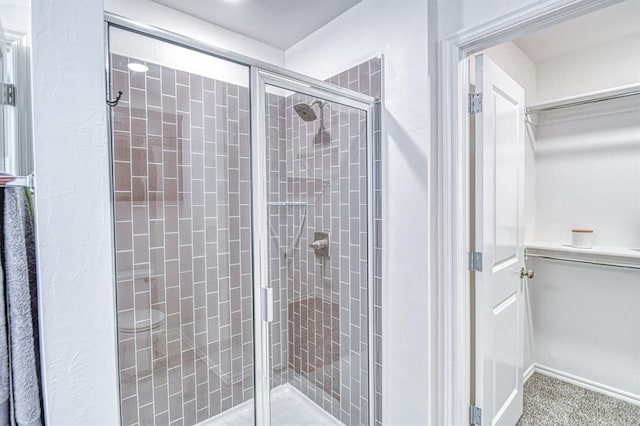 12712 NW 4th St, Yukon, OK 73099 - full bathroom featuring a stall shower and a walk in closet