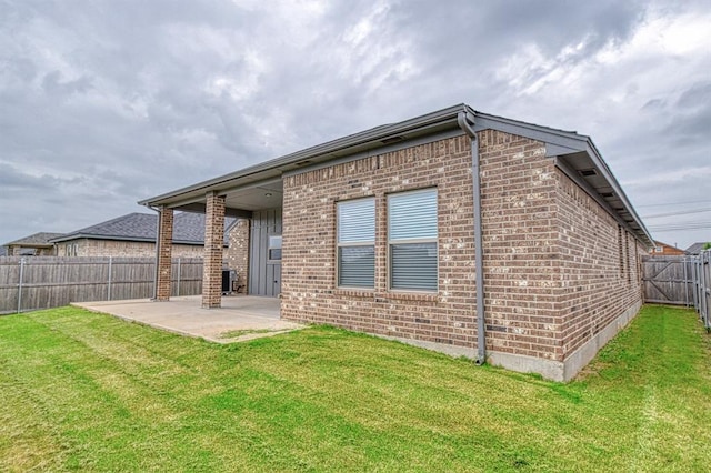 12712 NW 4th St, Yukon, OK 73099 - back of property with brick siding, a patio, and a fenced backyard