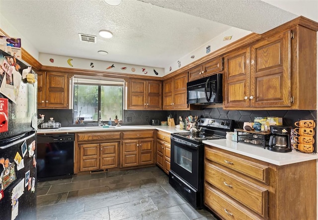 12725 Silver Ln, Oklahoma City, OK 73120 - kitchen featuring black appliances, brown cabinetry, light countertops, tasteful backsplash, and a textured ceiling