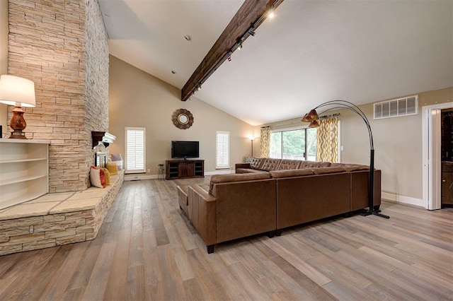 1810 Sandpiper Dr, Edmond, OK 73034 - living room featuring rail lighting, light wood-style flooring, beamed ceiling, and high vaulted ceiling