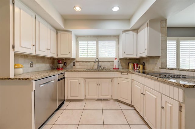 1810 Sandpiper Dr, Edmond, OK 73034 - kitchen featuring stainless steel dishwasher, tasteful backsplash, white cabinets, and recessed lighting