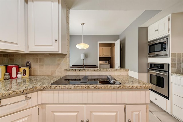 1810 Sandpiper Dr, Edmond, OK 73034 - kitchen with stainless steel appliances, tasteful backsplash, white cabinetry, washer / clothes dryer, and light stone countertops