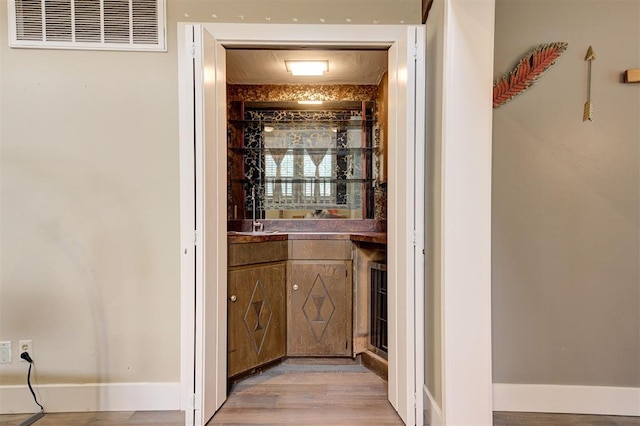 1810 Sandpiper Dr, Edmond, OK 73034 - bar featuring light wood-type flooring and baseboards