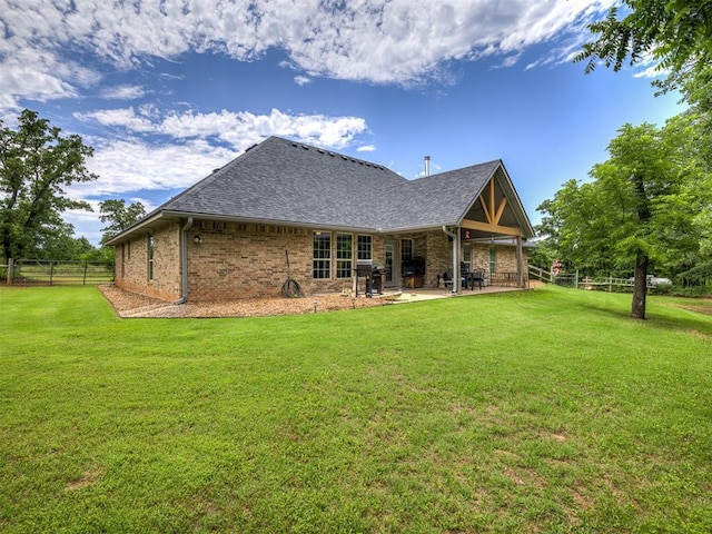 940908 S 3300th Rd, Luther, OK 73054 - rear view of property featuring a patio, a shingled roof, and brick siding