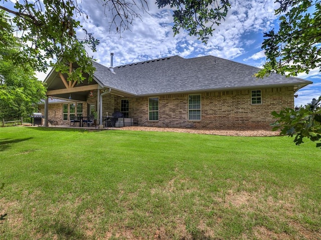 940908 S 3300th Rd, Luther, OK 73054 - back of house with a lawn, a patio area, a shingled roof, and brick siding